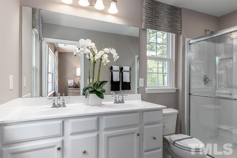6610 Pathfinder Way Raleigh, NC 27616 - Photo 5 of 6 a bathroom with a double vanity sink mirror and toilet