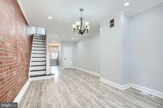 a view of a room with stairs and wooden floor