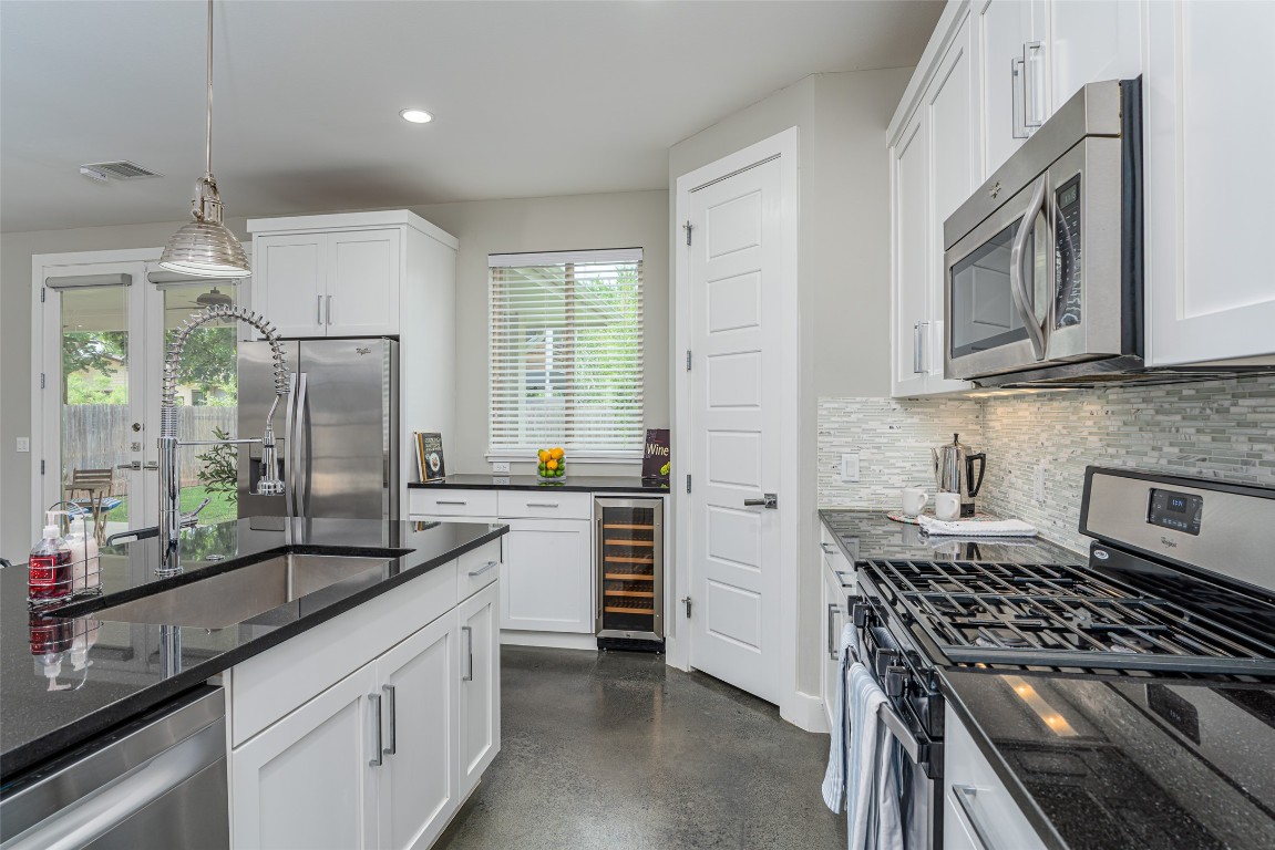 705 East 49th Street, Unit A Austin, TX 78751 - Photo 12 of 39 a kitchen with a stove a sink and a refrigerator