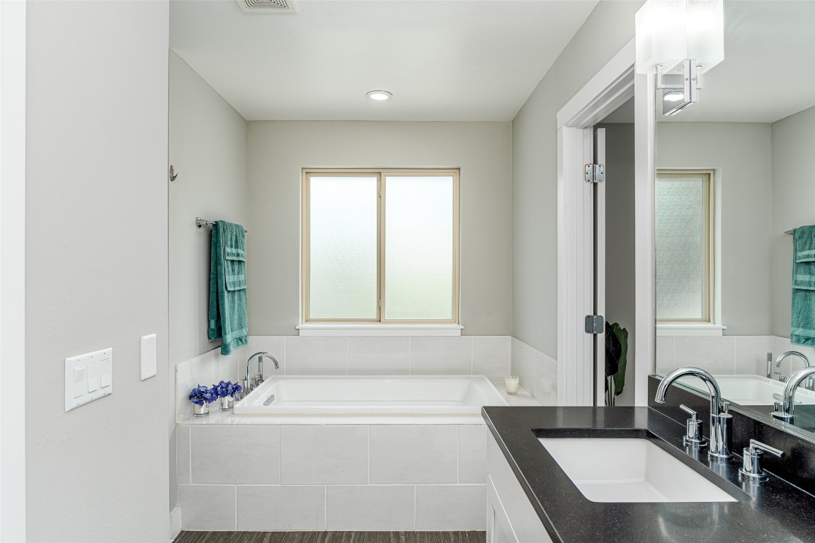 705 East 49th Street, Unit A Austin, TX 78751 - Photo 20 of 39 a bathroom with a tub sink and mirror
