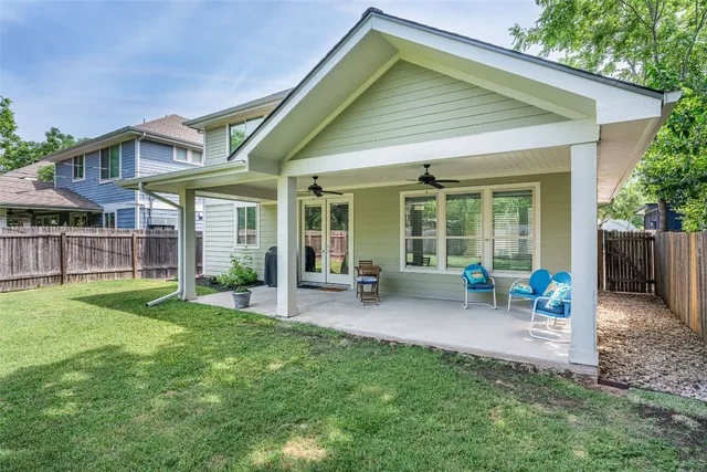 a view of a house with a yard and sitting area