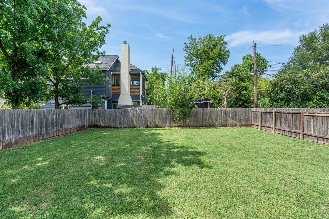 705 East 49th Street, Unit A Austin, TX 78751 - Photo 30 of 39 a view of a backyard with a trees and wooden fence