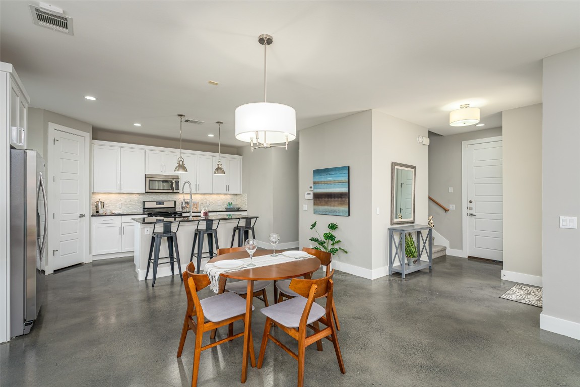 705 East 49th Street, Unit A Austin, TX 78751 - Photo 9 of 39 a view of a dining room with furniture and a chandelier