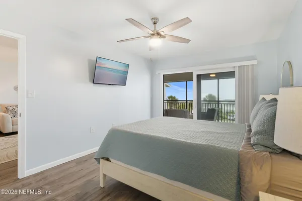 a bathroom with a granite countertop sink a toilet and shower curtain
