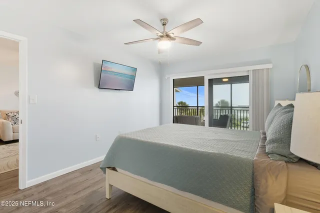 a bathroom with a granite countertop sink a toilet and shower curtain