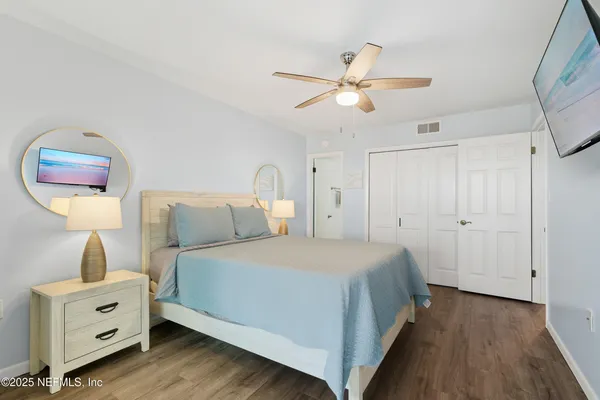 a bedroom with a bed and a painting on the wall