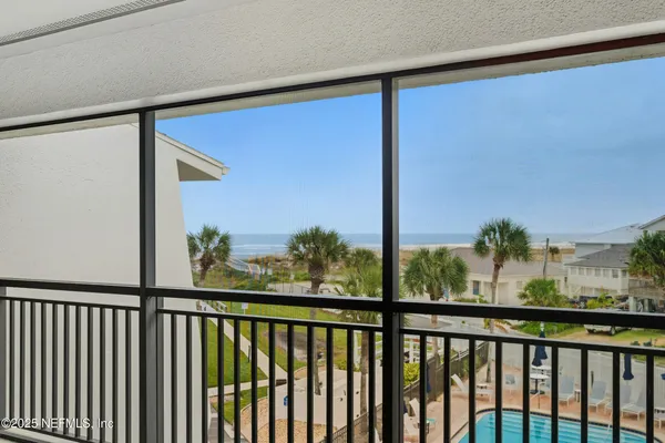 a view of a swimming pool with a lounge chair