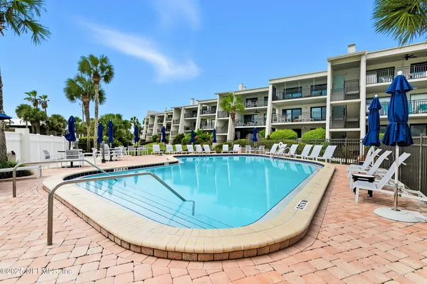 a view of a swimming pool with outdoor seating