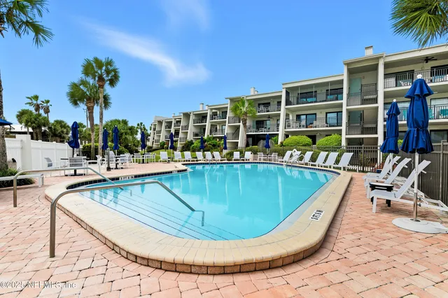 a view of a swimming pool with outdoor seating