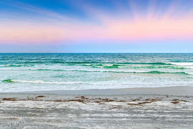 a view of a house with a yard and lake view