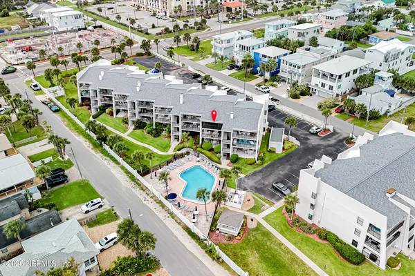 an aerial view of residential houses with outdoor space