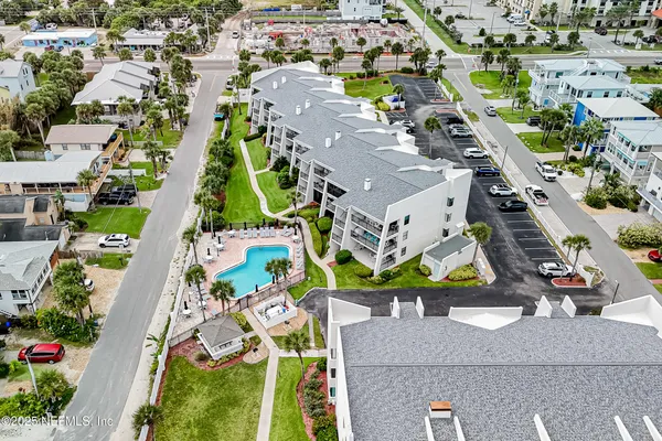 an aerial view of residential houses with outdoor space