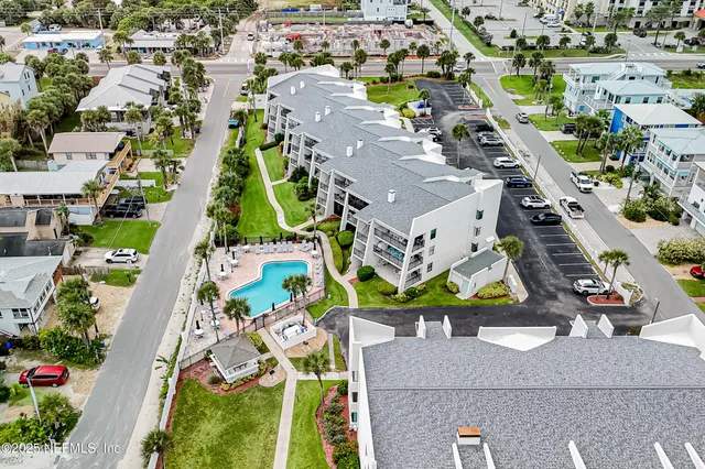 an aerial view of residential houses with outdoor space