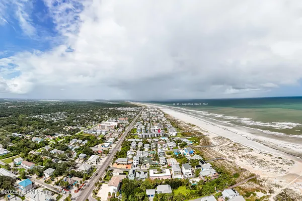 a front view of a house with a yard and palm trees
