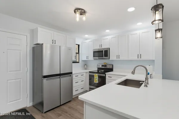 a kitchen with stainless steel appliances kitchen island granite countertop a sink and cabinets