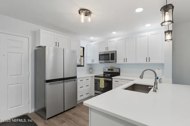 a kitchen with stainless steel appliances kitchen island granite countertop a sink and cabinets