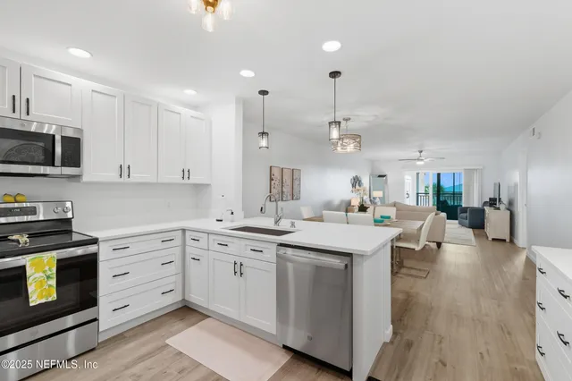 a kitchen with stainless steel appliances a refrigerator stove microwave and sink