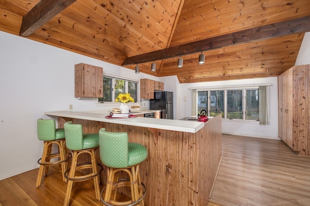 61 Tide Run Mashpee, MA 02649 - Photo 11 of 39 a view of a dining room with furniture window and wooden floor