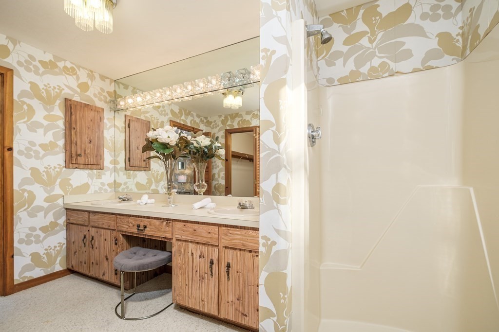 61 Tide Run Mashpee, MA 02649 - Photo 22 of 39 a bathroom with a granite countertop sink a mirror and a shower