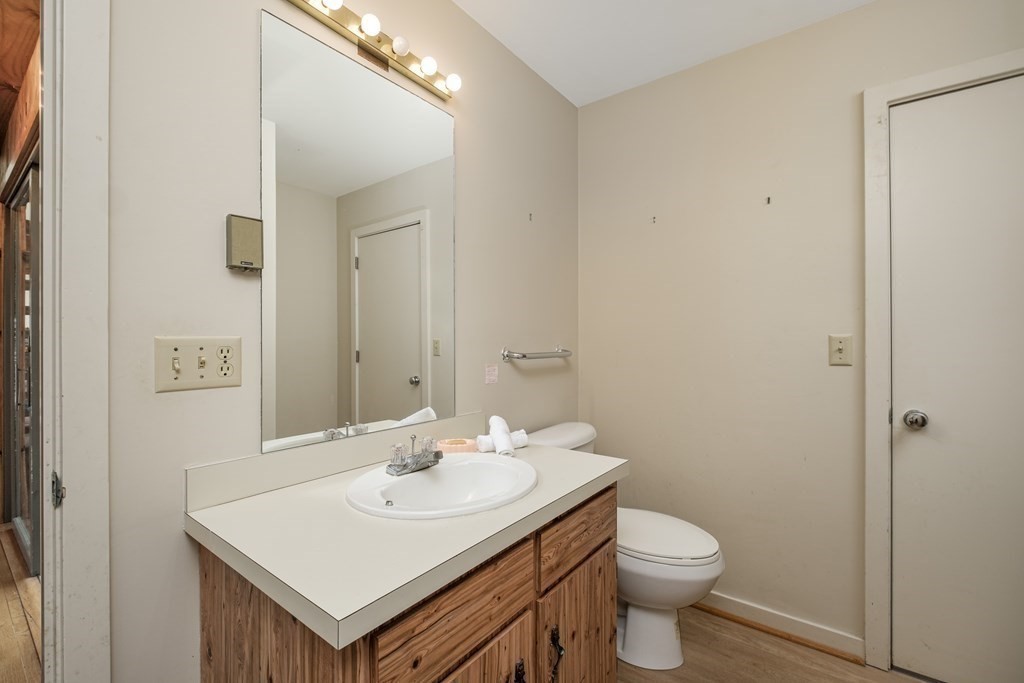 61 Tide Run Mashpee, MA 02649 - Photo 24 of 39 a bathroom with a sink a toilet and a mirror
