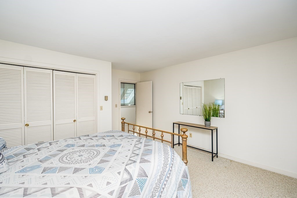 61 Tide Run Mashpee, MA 02649 - Photo 26 of 39 a spacious bedroom with a bed and a window