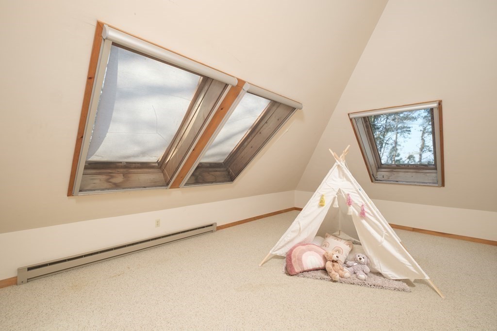 61 Tide Run Mashpee, MA 02649 - Photo 31 of 39 a room with a bed and a painting on the wall