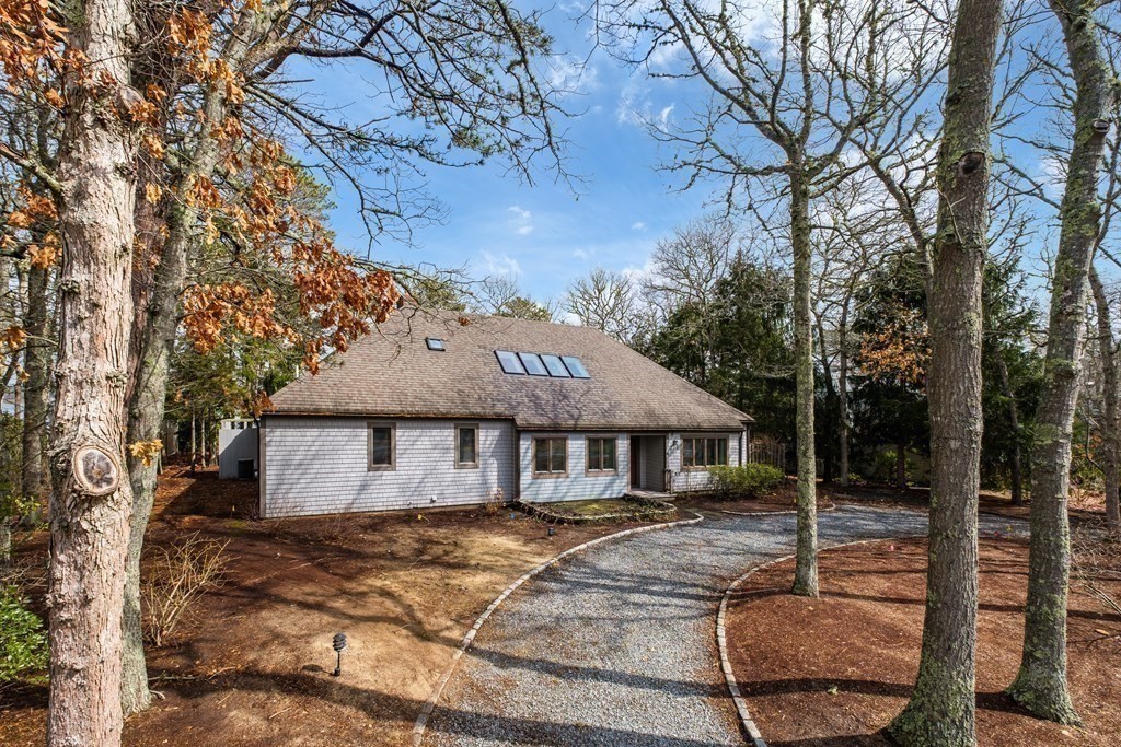 61 Tide Run Mashpee, MA 02649 - Photo 8 of 39 a front view of a house with garden