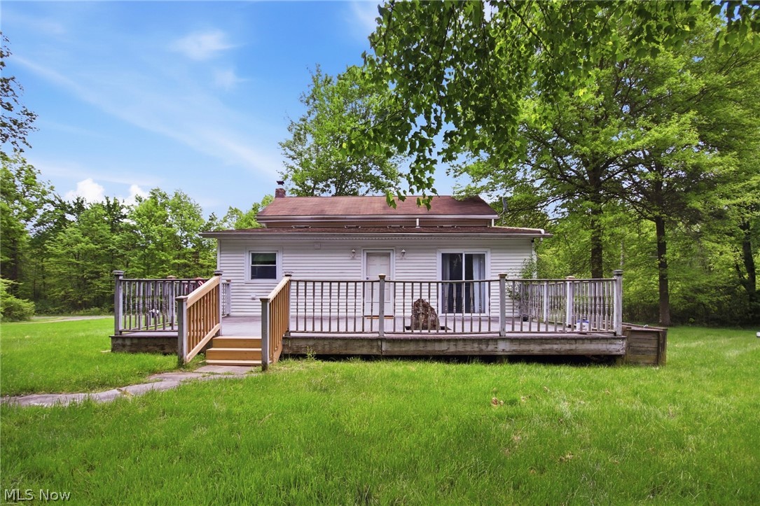 2591 Wayland Road Deerfield, OH 44411 - Photo 37 of 46 Exterior featuring a wooden deck with railing, a sliding glass door, white siding, and a brown shingle roof