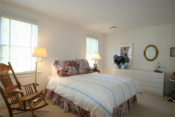 45 Deerpath Road Dedham, MA 02026 - Photo 9 of 12 a bedroom with a bed and a chandelier