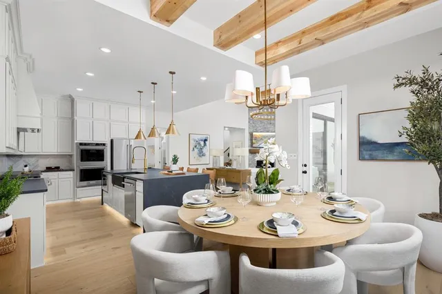 a view of a dining room with furniture and chandelier