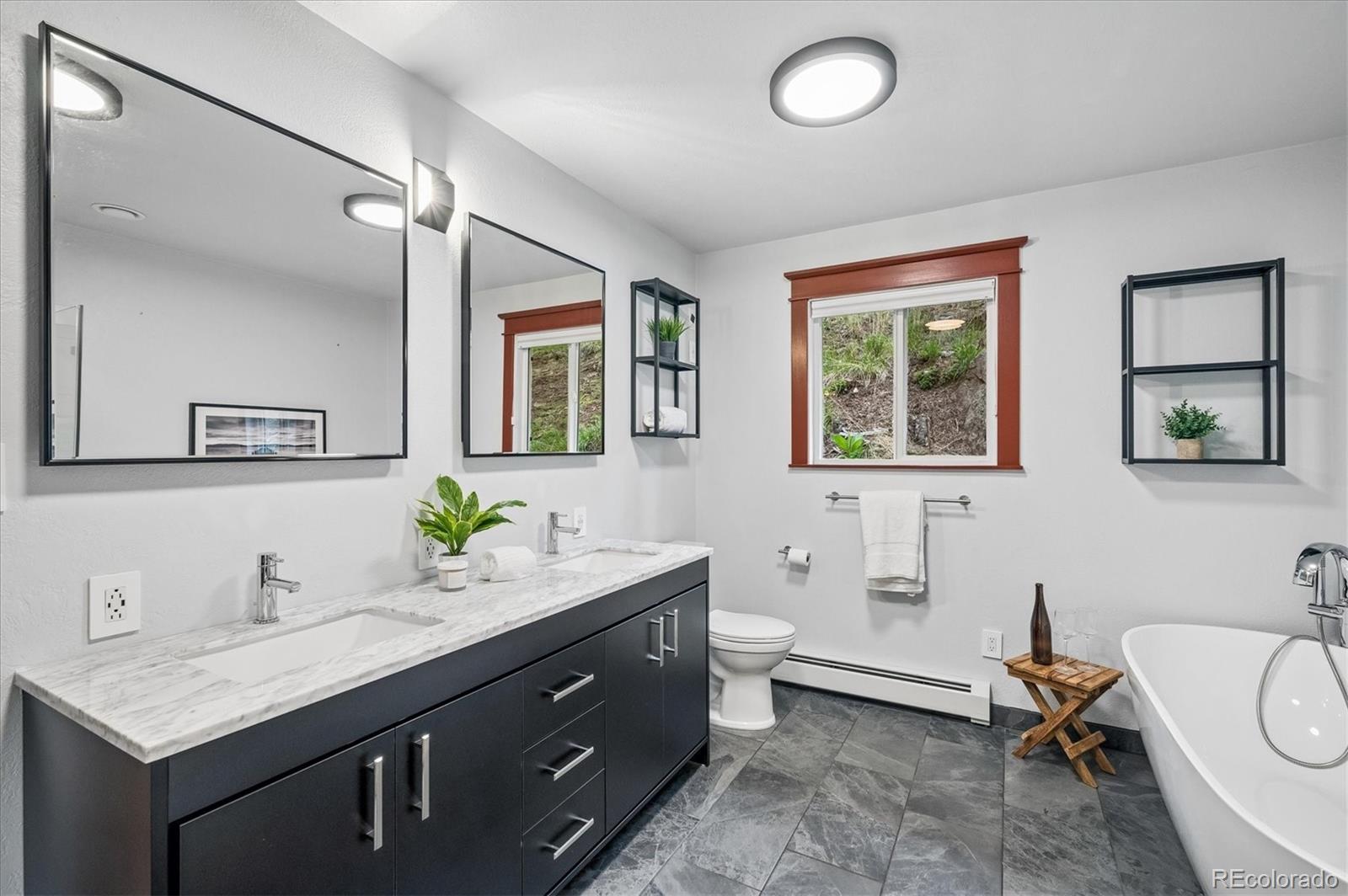 6747 South Brook Forest Road Evergreen, CO 80439 - Photo 23 of 49 a bathroom with a granite countertop sink mirror and a