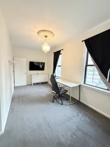 a room with gym equipment and a view of living room