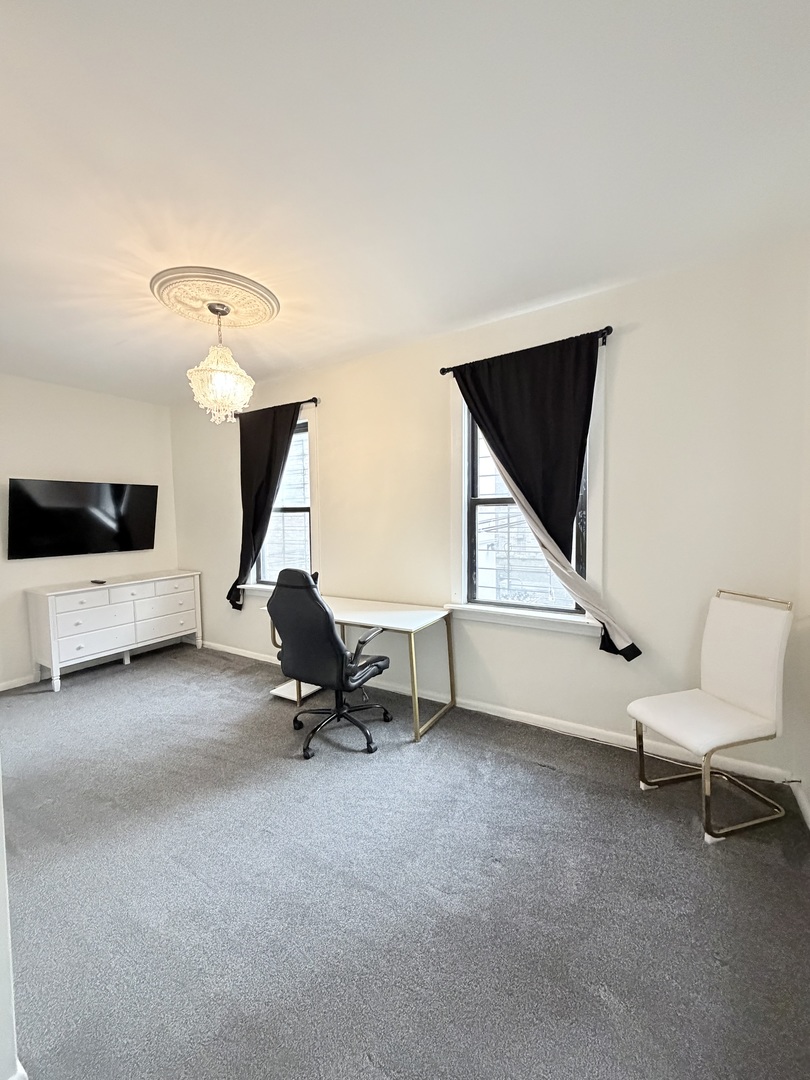 642 North Dearborn Street, Unit CH Chicago, IL 60654 - Photo 19 of 19 a room with gym equipment and a view of living room