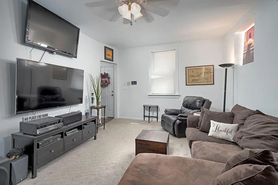 642 North Dearborn Street, Unit CH Chicago, IL 60654 - Photo 3 of 19 a living room with furniture and a flat screen tv