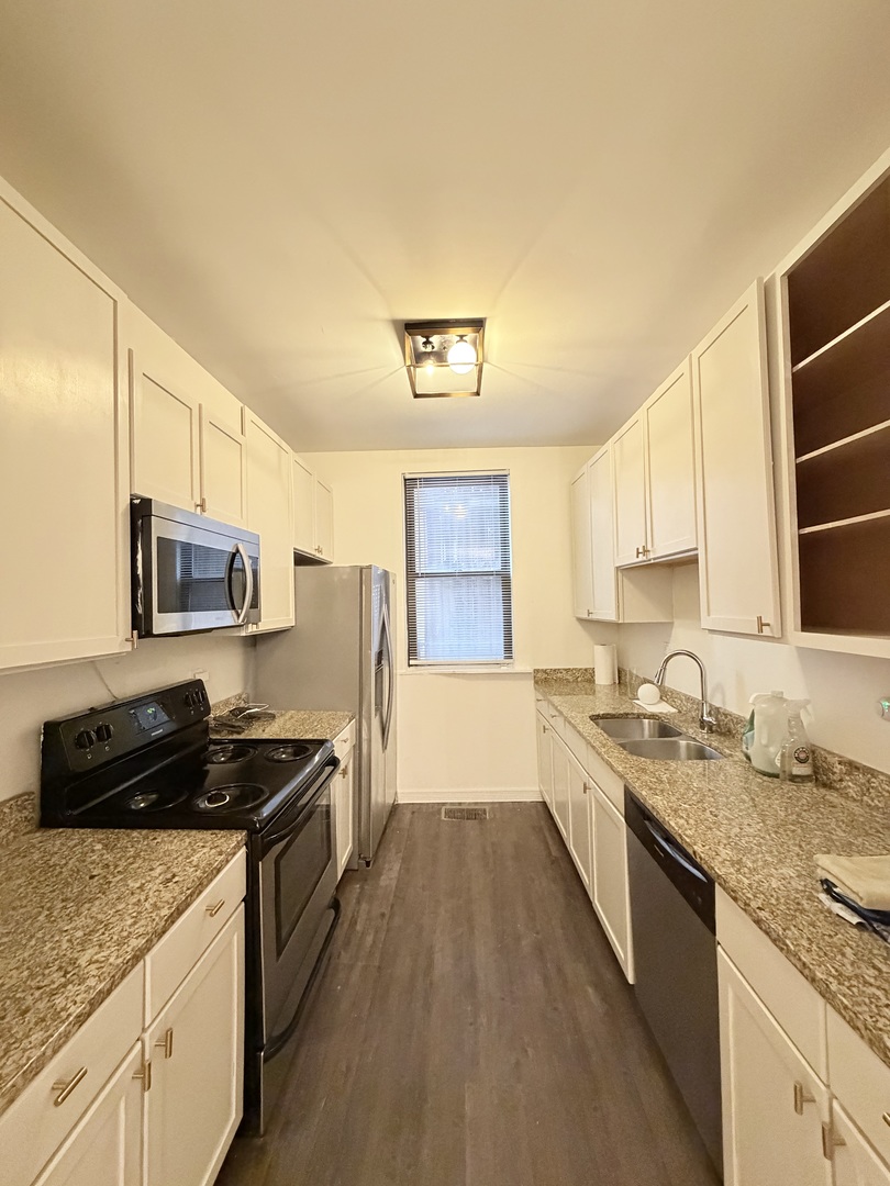 642 North Dearborn Street, Unit CH Chicago, IL 60654 - Photo 6 of 19 a kitchen with a sink stove top oven and microwave
