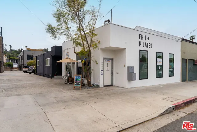 a view of a building with car parked