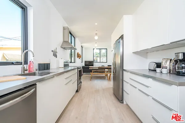 a kitchen with a sink stove and cabinets