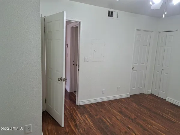a view of an empty room with wooden floor