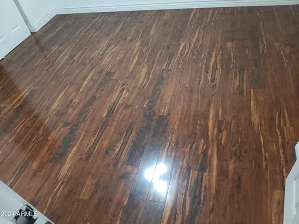 an empty room with wooden floor and closet