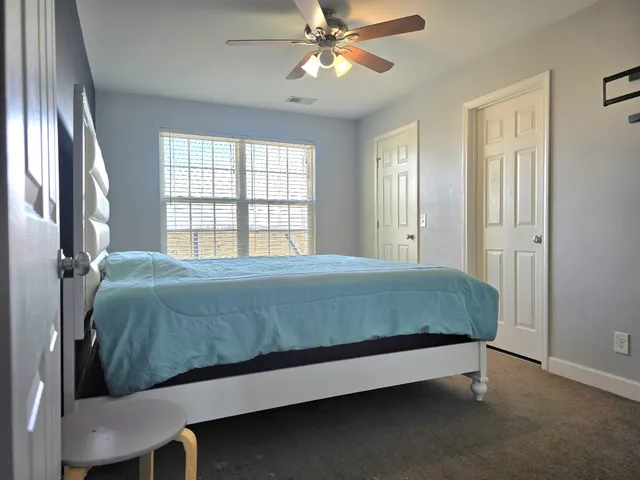 a bedroom with a bed and window