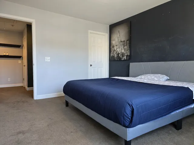 a bedroom with a bed and window