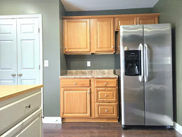 a kitchen with stainless steel appliances granite countertop a refrigerator and a sink