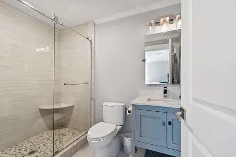 a bathroom with a sink toilet and a mirror