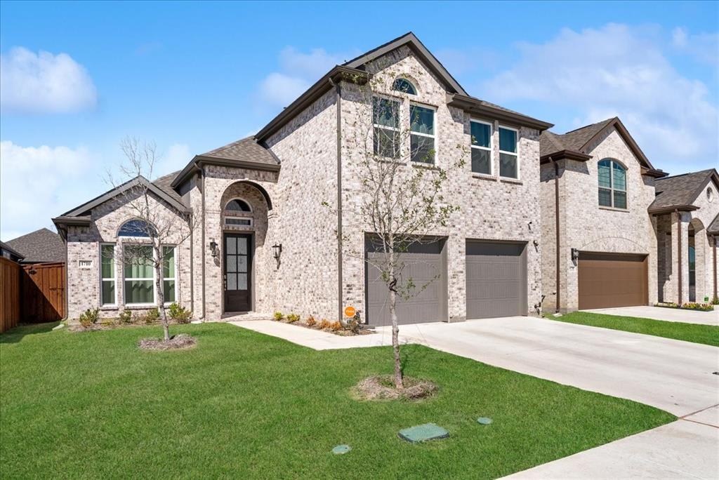 1710 Highwood Road Forney, TX 75126 - Photo 18 of 25 Two-story brick facade residence with an arched entry and a dark paneled front door
