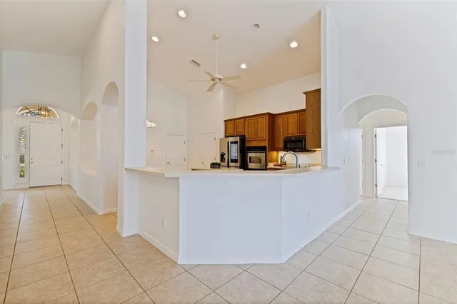 a view of kitchen with refrigerator and window