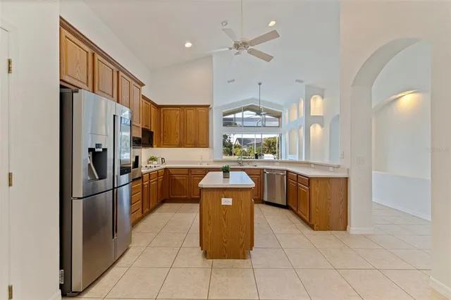 a kitchen with stainless steel appliances granite countertop a refrigerator a stove a sink and a refrigerator