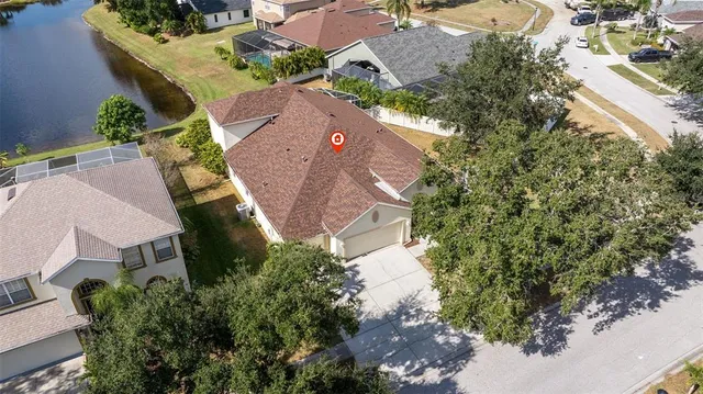 an aerial view of a house with yard and outdoor seating