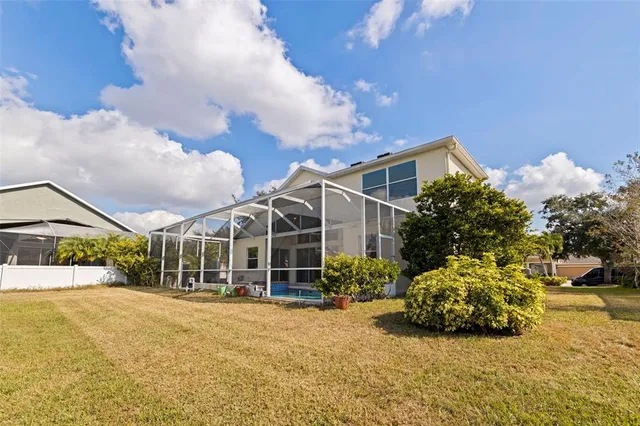 an aerial view of residential houses with outdoor space and lake view