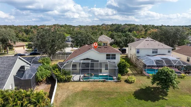 an aerial view of a house with a yard and lake view