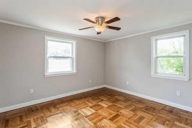 a view of a room with window and ceiling fan